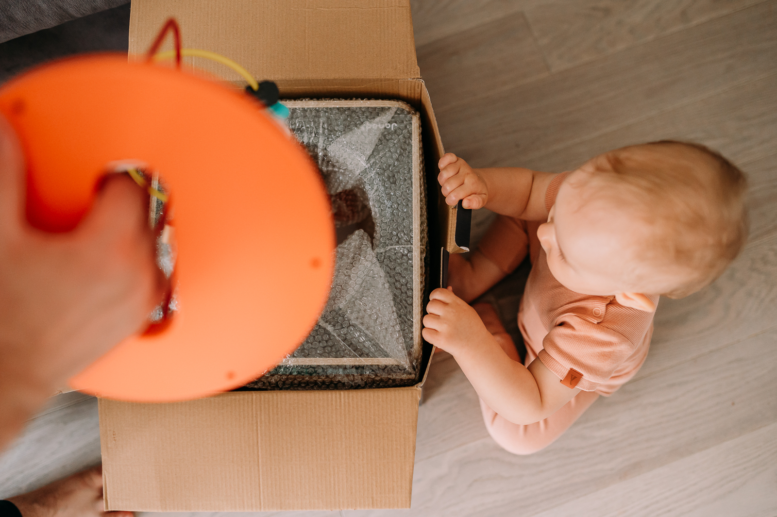 dziecko rozpakowuje prezent na pierwsze urodziny